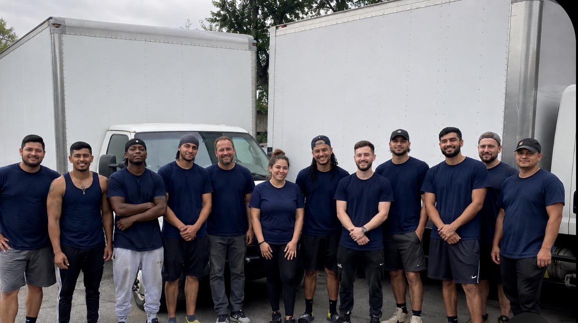 Allo Moving team standing in front of moving trucks in Montreal